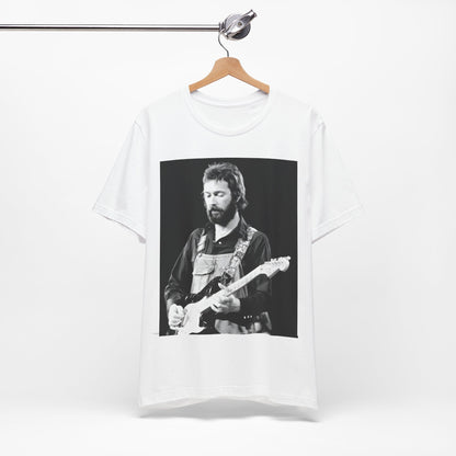 A black graphic t-shirt featuring a graphic or photo of Eric Clapton performing live on stage with his guitar.