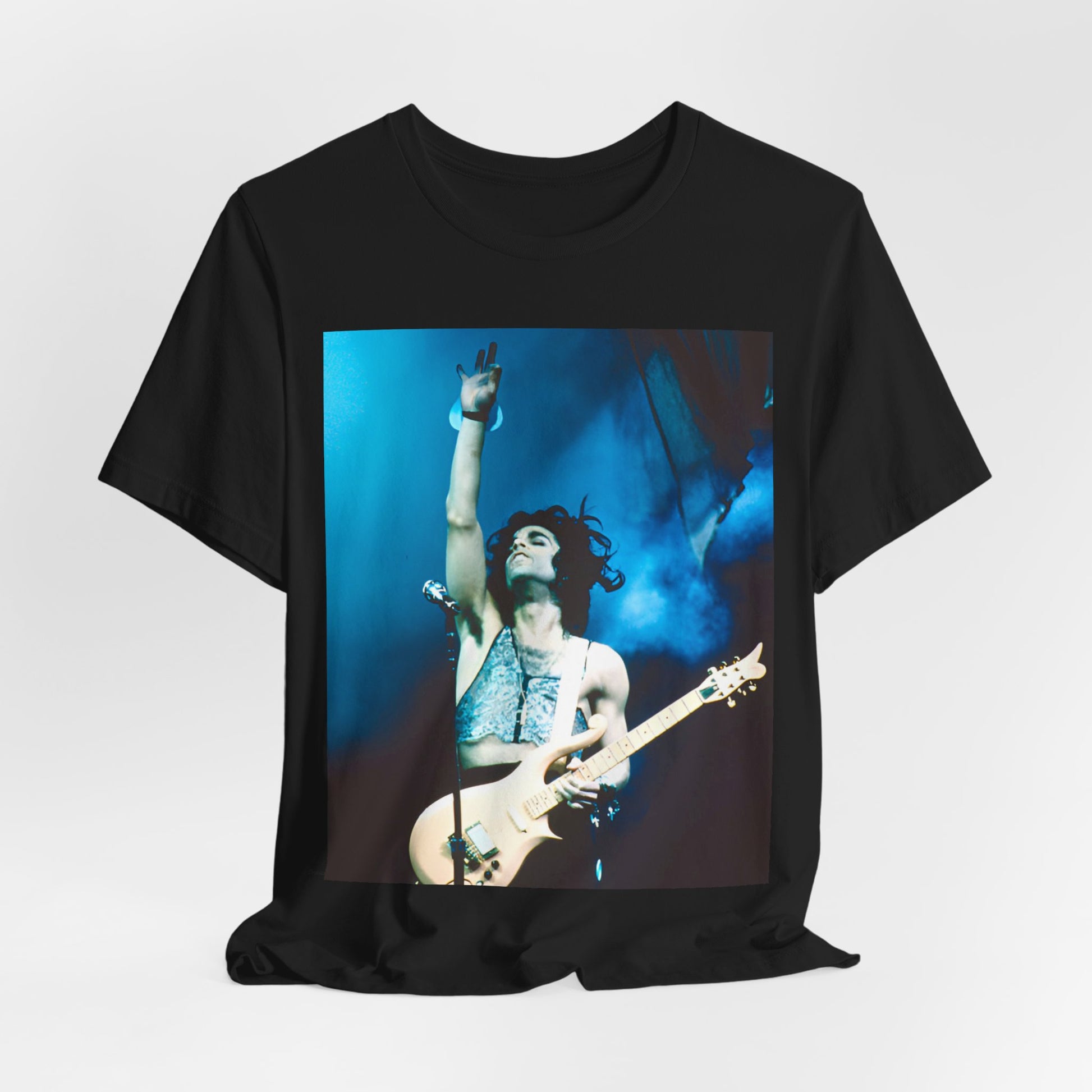 A black graphic t-shirt featuring a graphic of Prince as a guitar god and virtuoso performer.