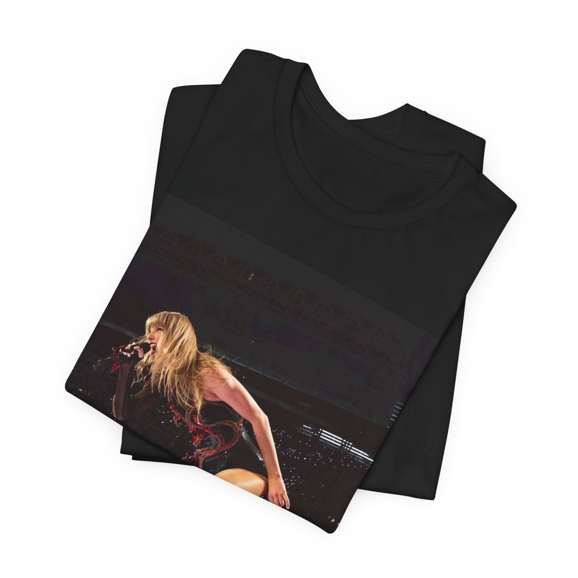 A black graphic t-shirt featuring a fierce graphic of Taylor Swift on stage.