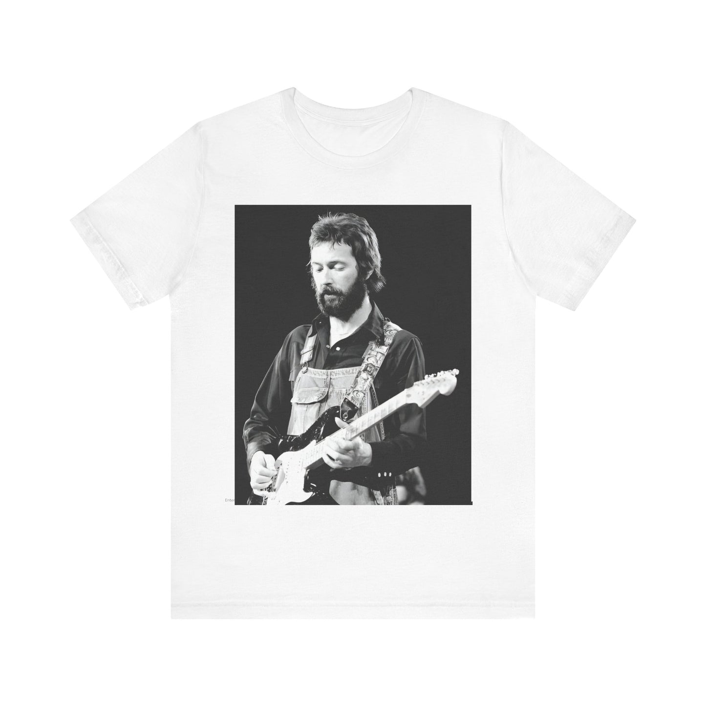 A black graphic t-shirt featuring a graphic or photo of Eric Clapton performing live on stage with his guitar.