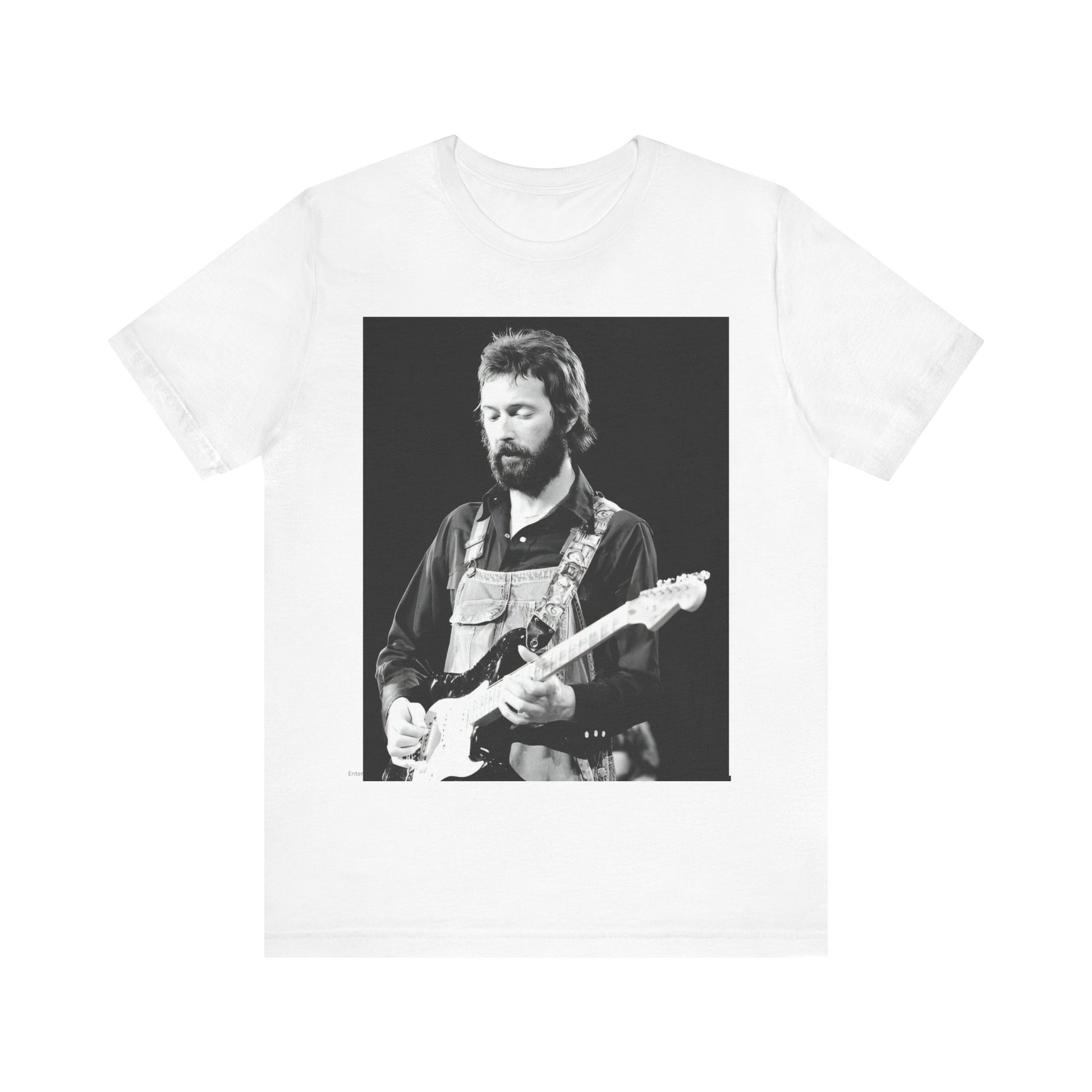 A black graphic t-shirt featuring a graphic or photo of Eric Clapton performing live on stage with his guitar.