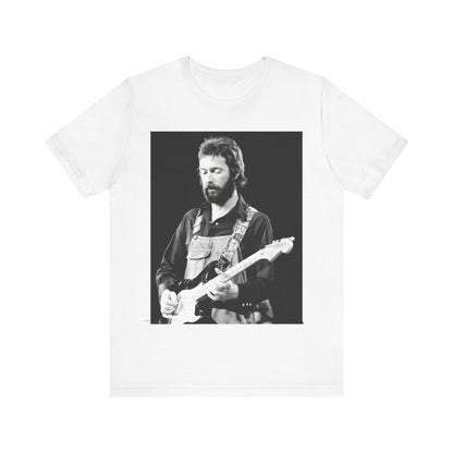 A black graphic t-shirt featuring a graphic or photo of Eric Clapton performing live on stage with his guitar.