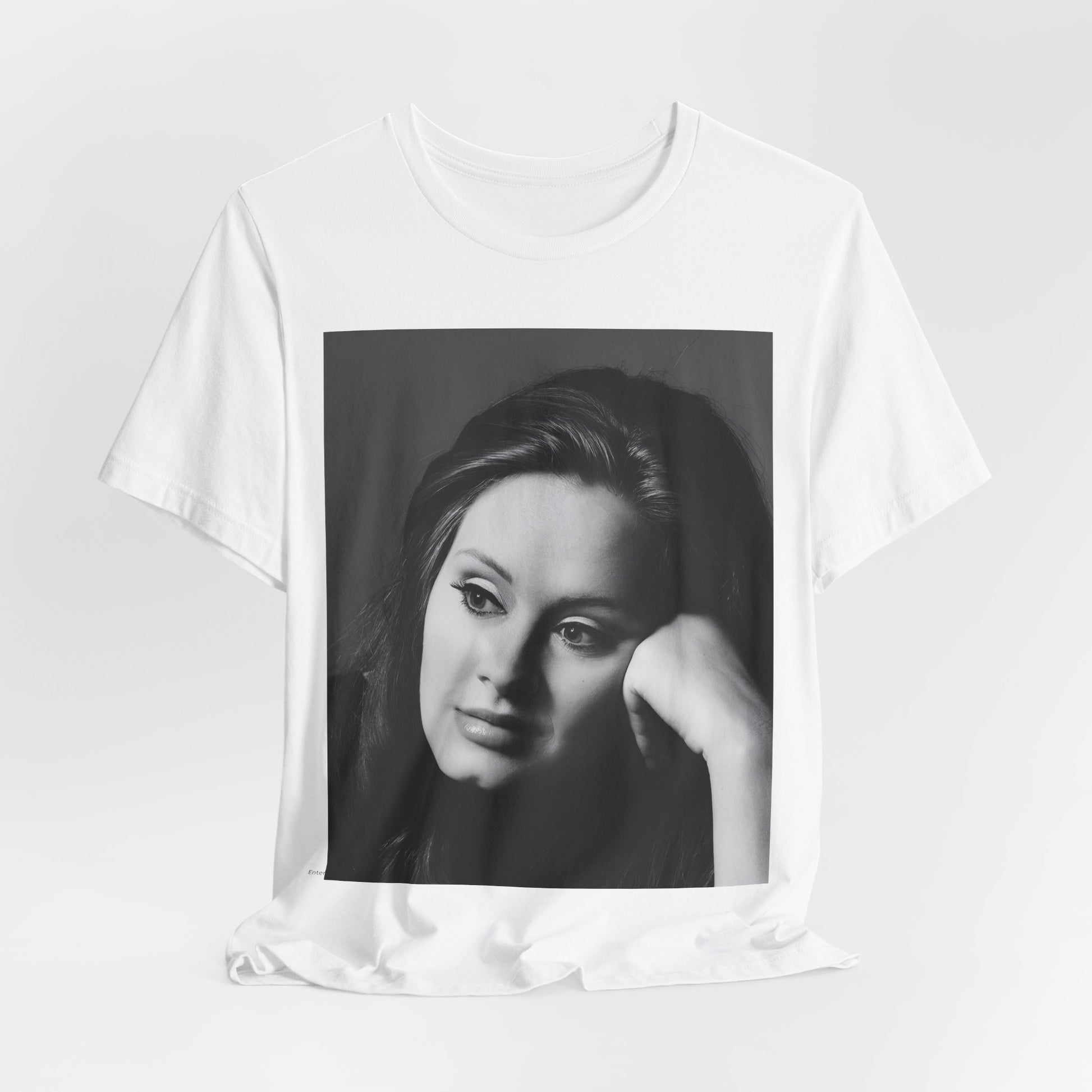 A black graphic t-shirt featuring a vintage-style black and white studio portrait of Adele, showing her with a poised and elegant expression.