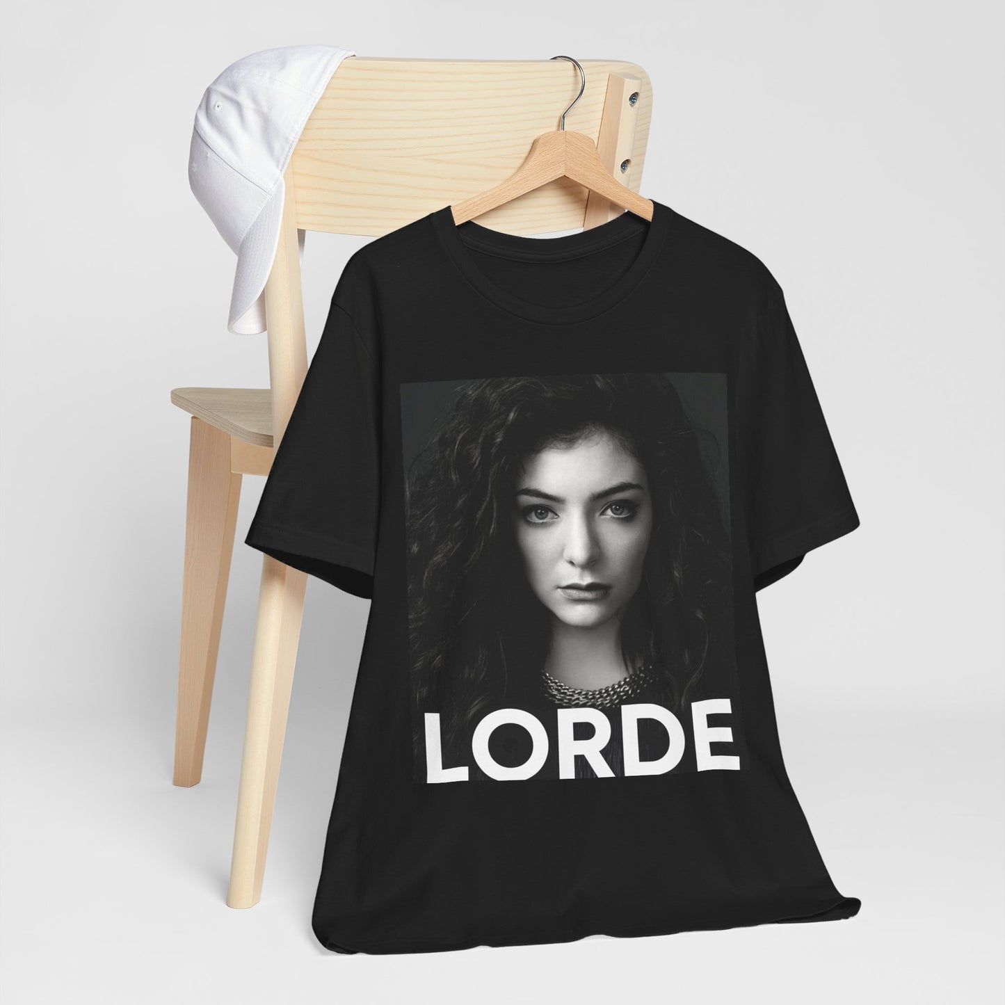 A black graphic t-shirt featuring a casual pop fan graphic of Lorde.