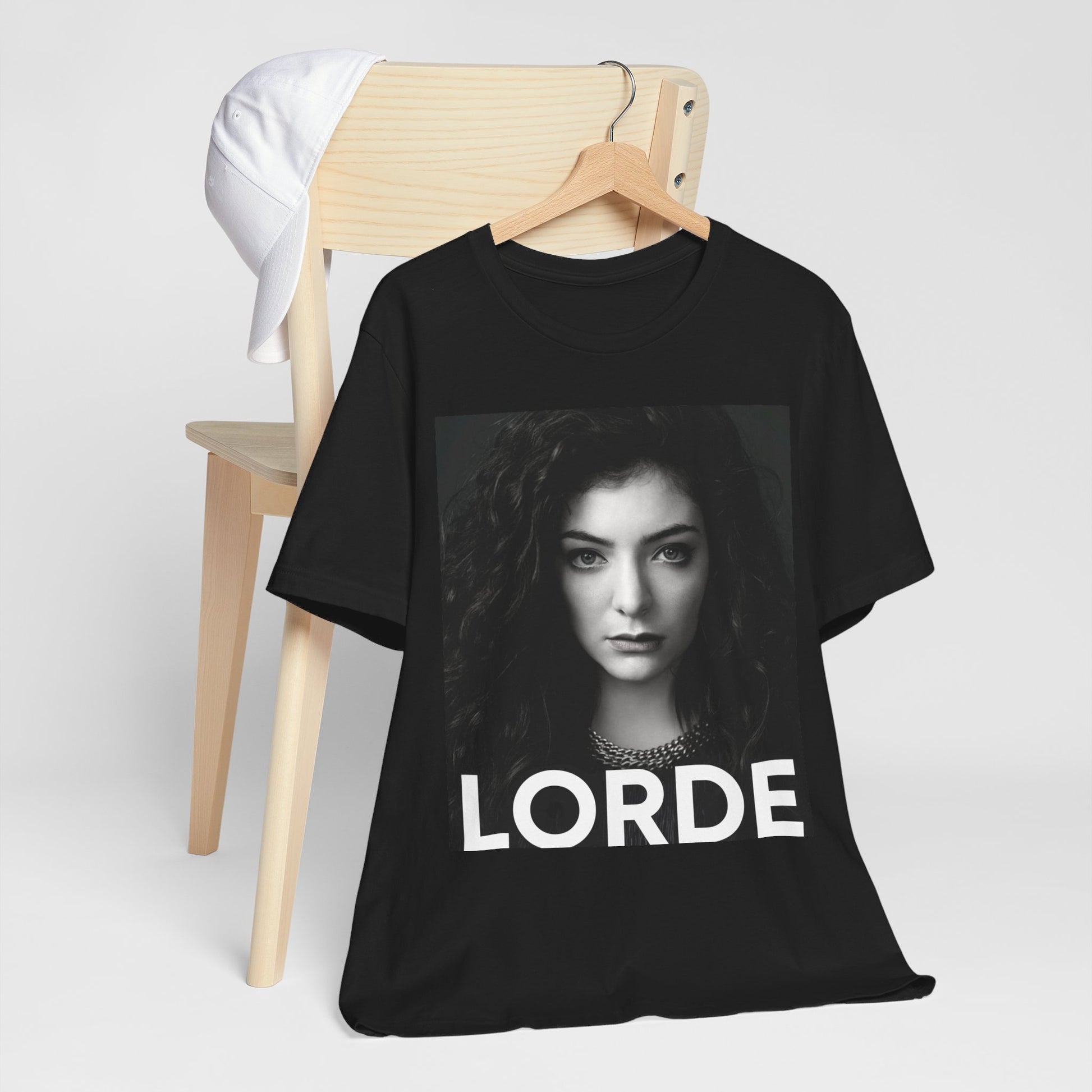 A black graphic t-shirt featuring a casual pop fan graphic of Lorde.