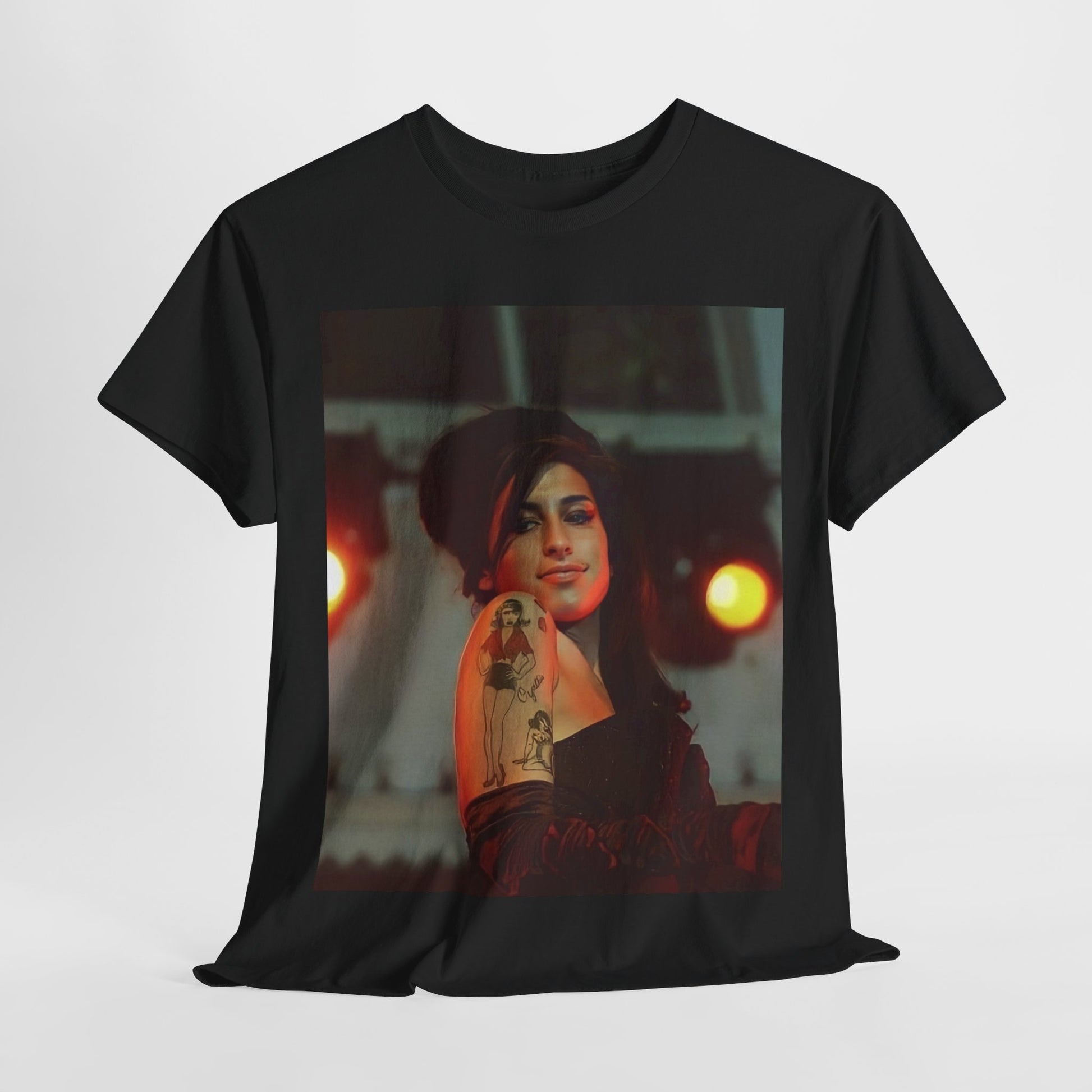 A black graphic t-shirt featuring a stylized graphic of Amy Winehouse, possibly with a crown or 'R&B Queen' text, emphasizing her soulful presence.