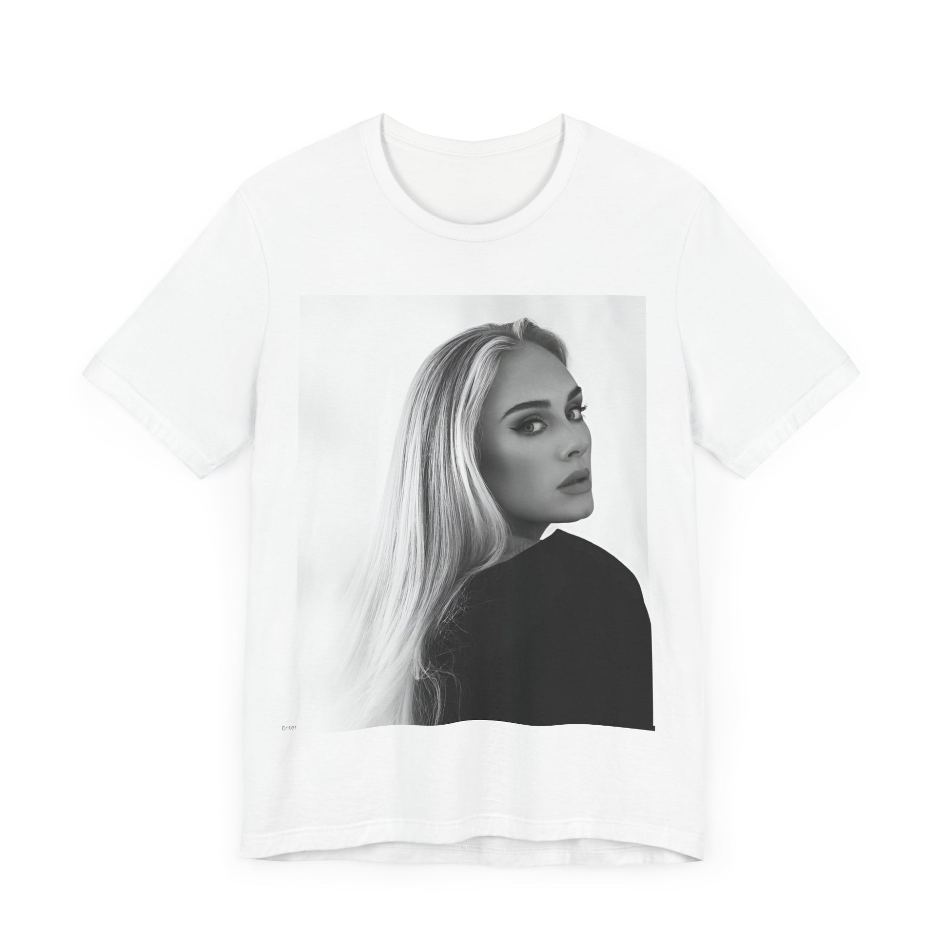 A black graphic t-shirt featuring a black and white, monochromatic portrait of Adele, showing her with a serene or thoughtful expression.