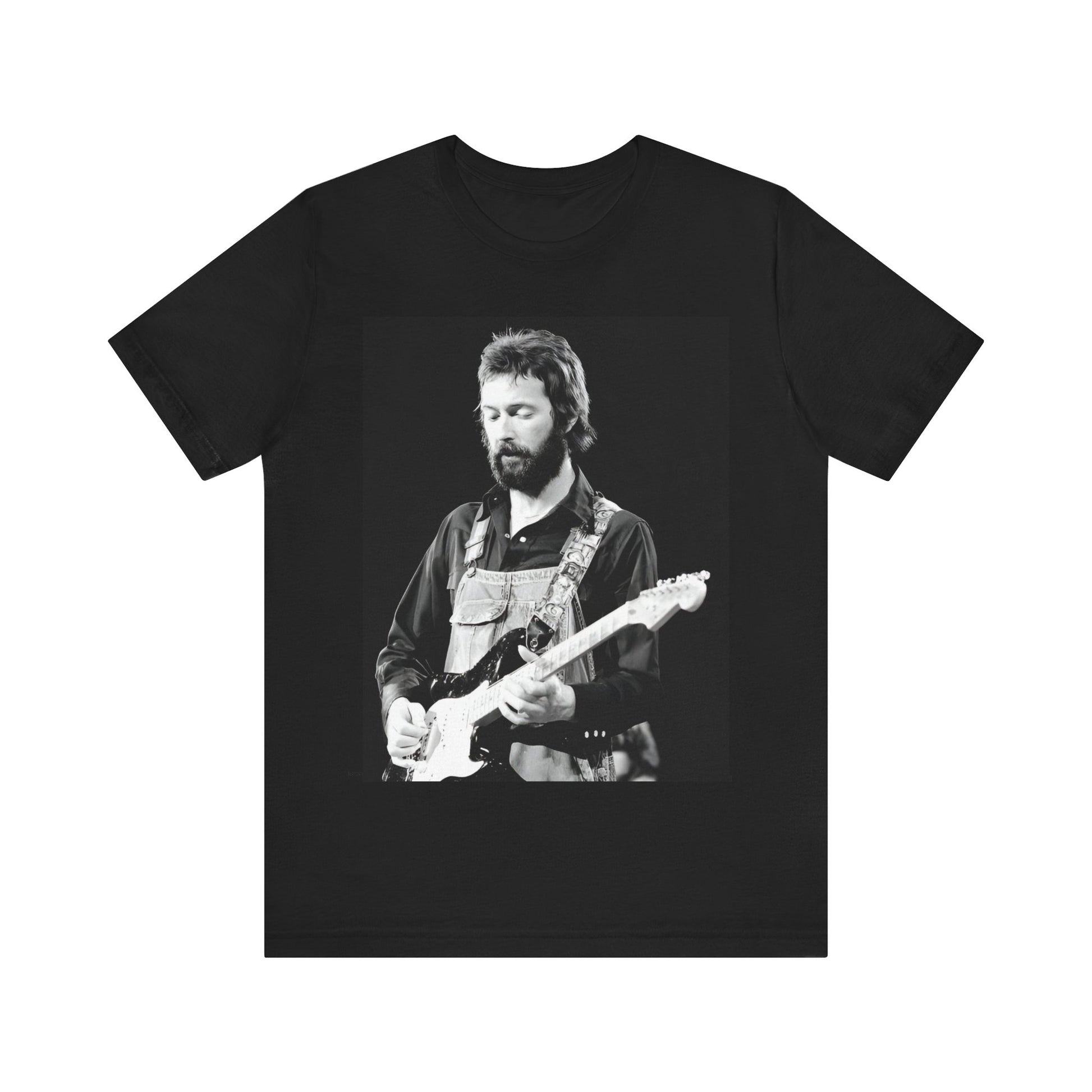A black graphic t-shirt featuring a graphic or photo of Eric Clapton performing live on stage with his guitar.