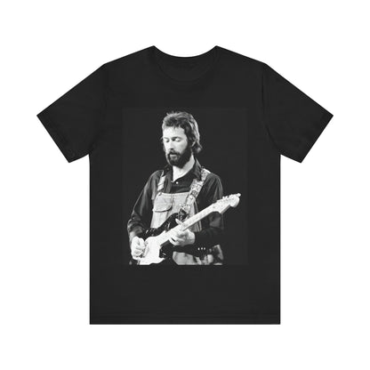 A black graphic t-shirt featuring a graphic or photo of Eric Clapton performing live on stage with his guitar.