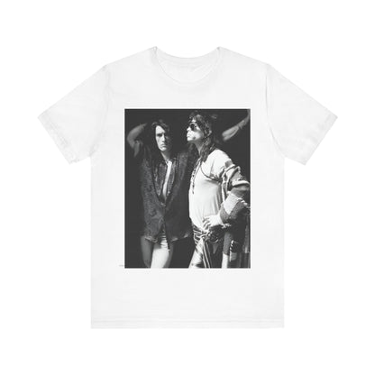 A black graphic t-shirt featuring a dynamic photo or illustration of Aerosmith's Steven Tyler and Joe Perry performing together on stage, highlighting their synergy.