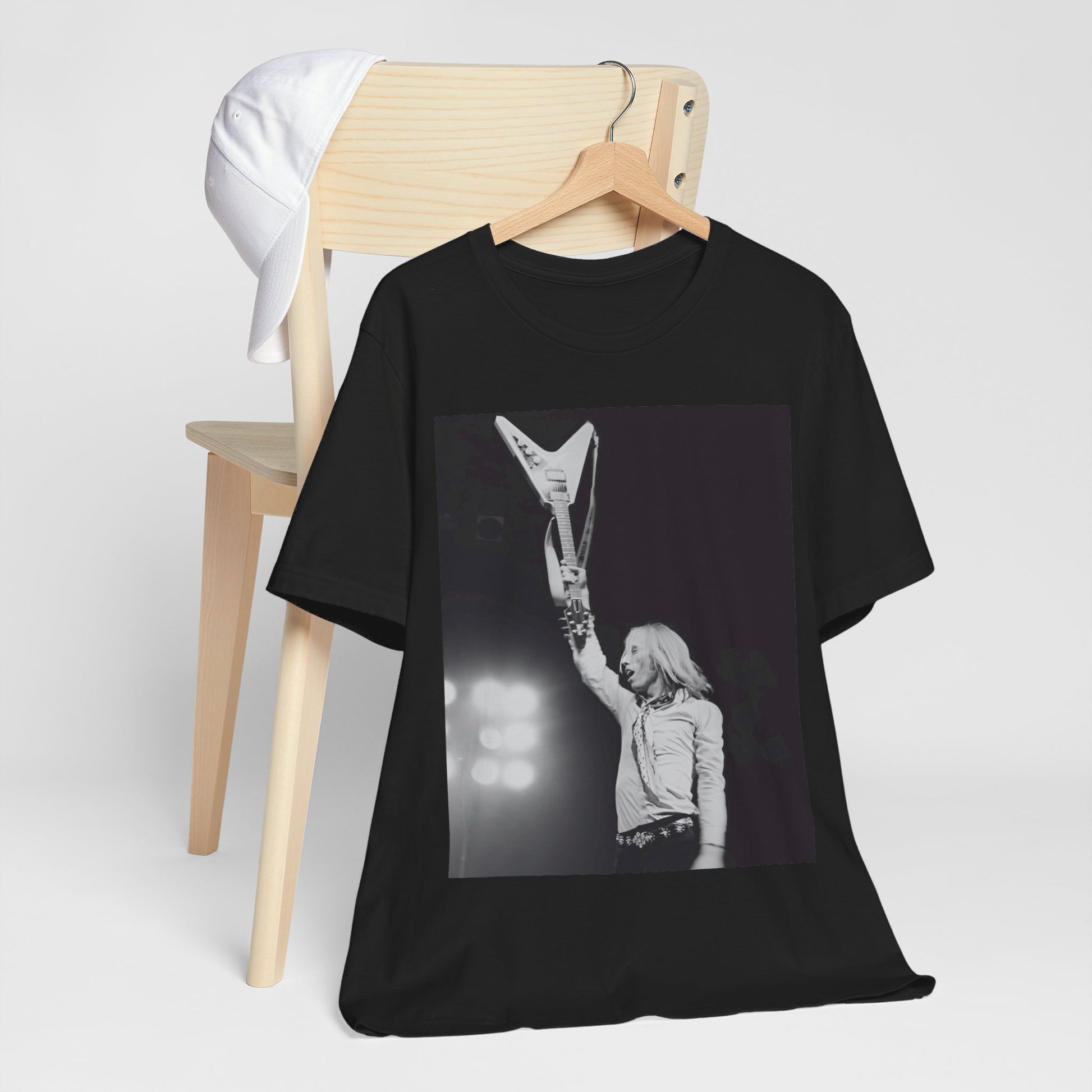 A black graphic t-shirt featuring a graphic or photo of Tom Petty playing guitar on stage.