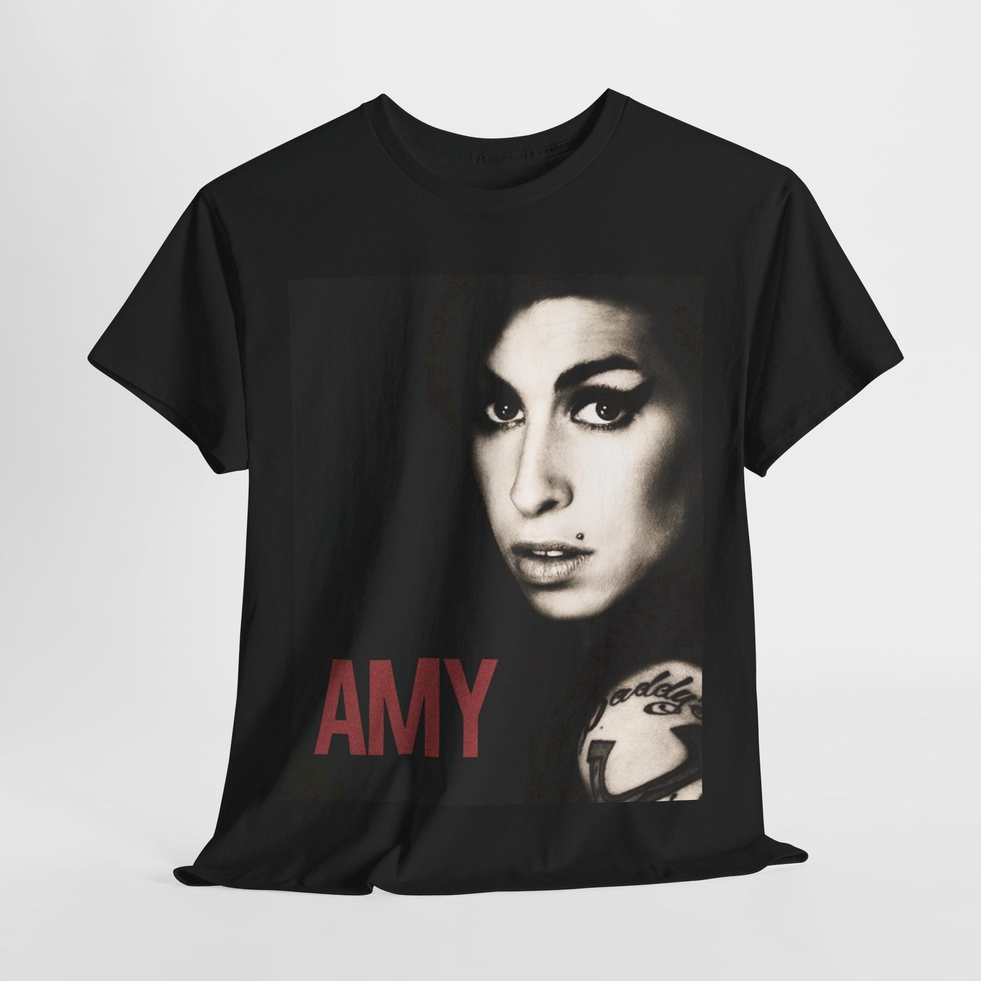 A black graphic t-shirt featuring a stylized graphic of Amy Winehouse, designed to represent her enduring legacy, possibly with her name or iconic elements.