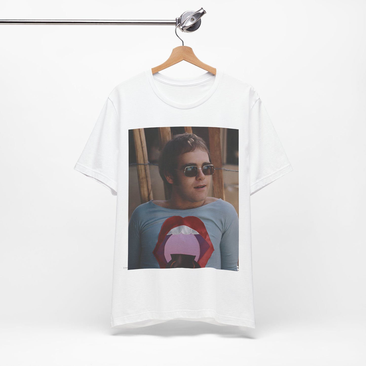A black graphic t-shirt featuring a classic graphic related to Elton John's 'Tiny Dancer' song or era.