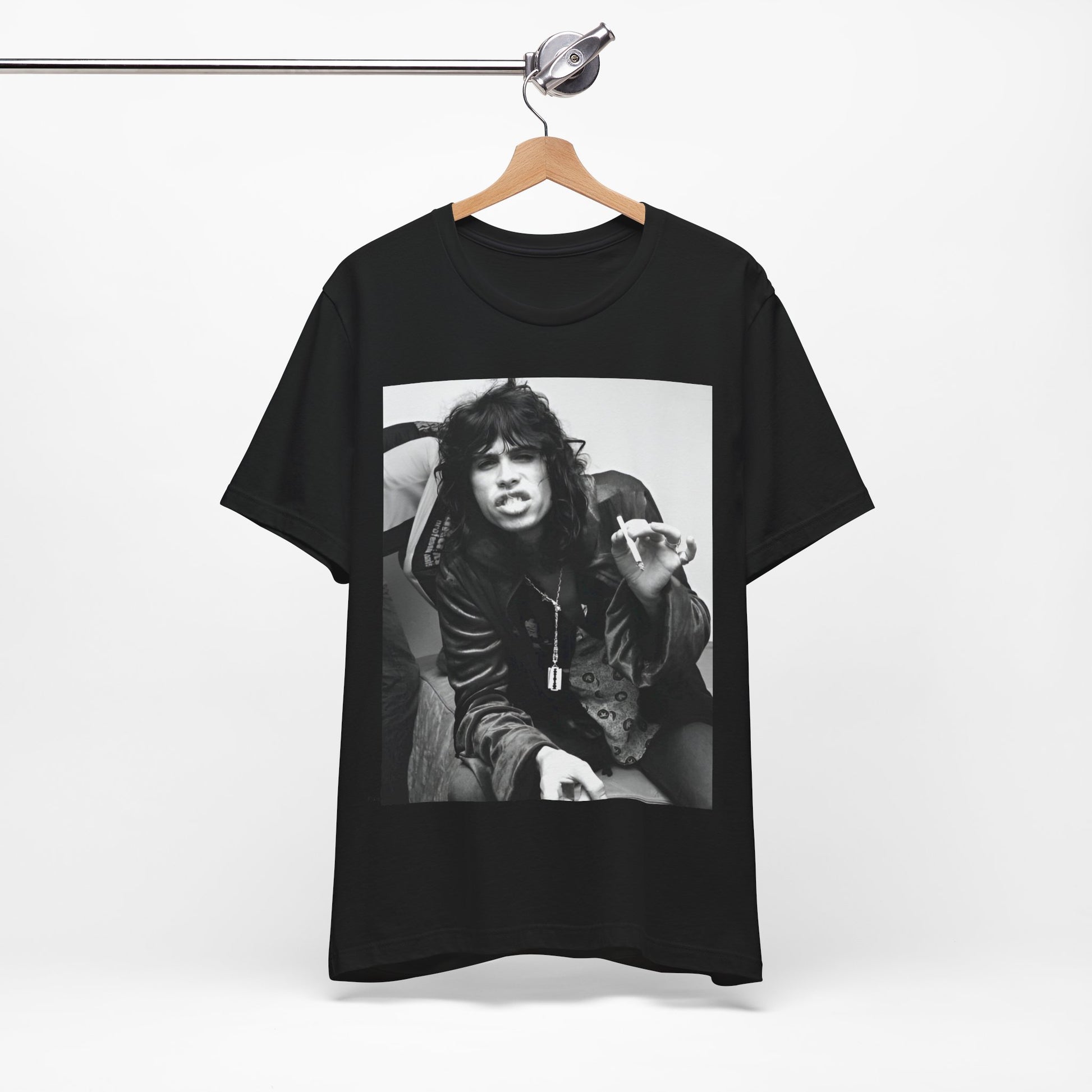 A black graphic t-shirt featuring a retro 70s photo of Aerosmith band members lounging in leather, exuding a cool, classic rock vibe.