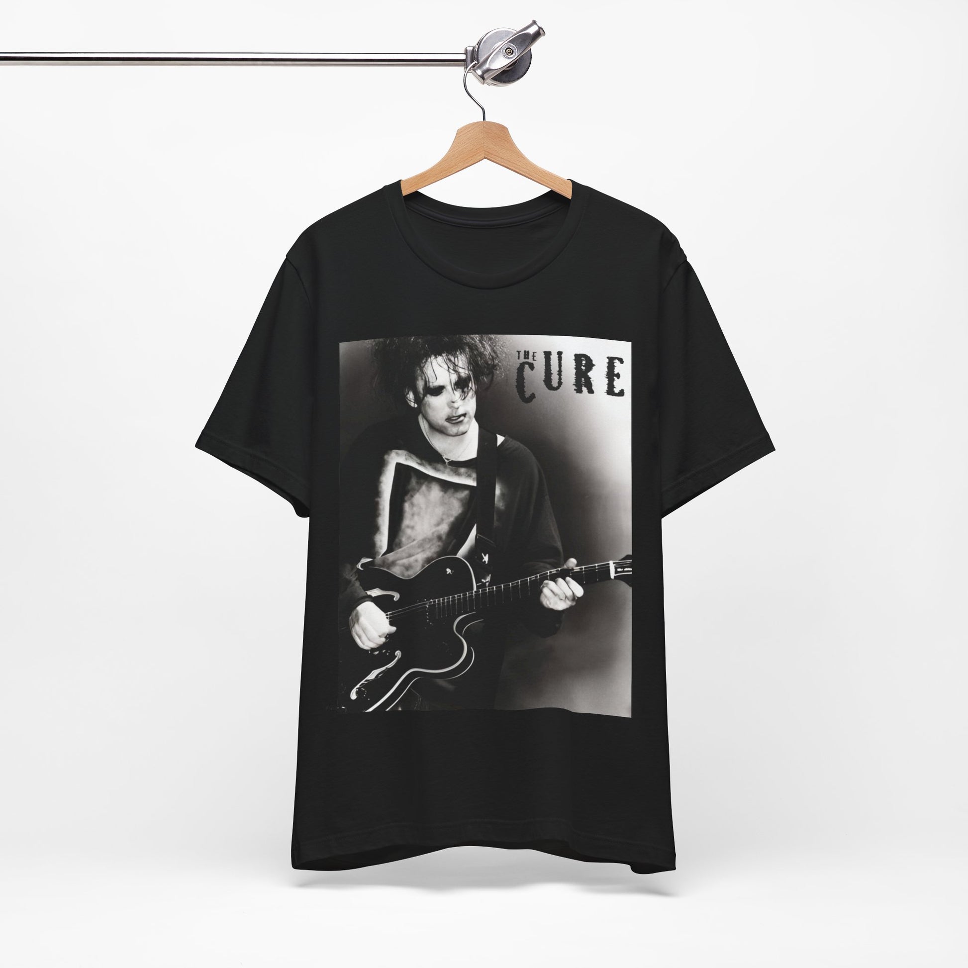 A black graphic t-shirt featuring a vintage goth rock graphic of The Cure.