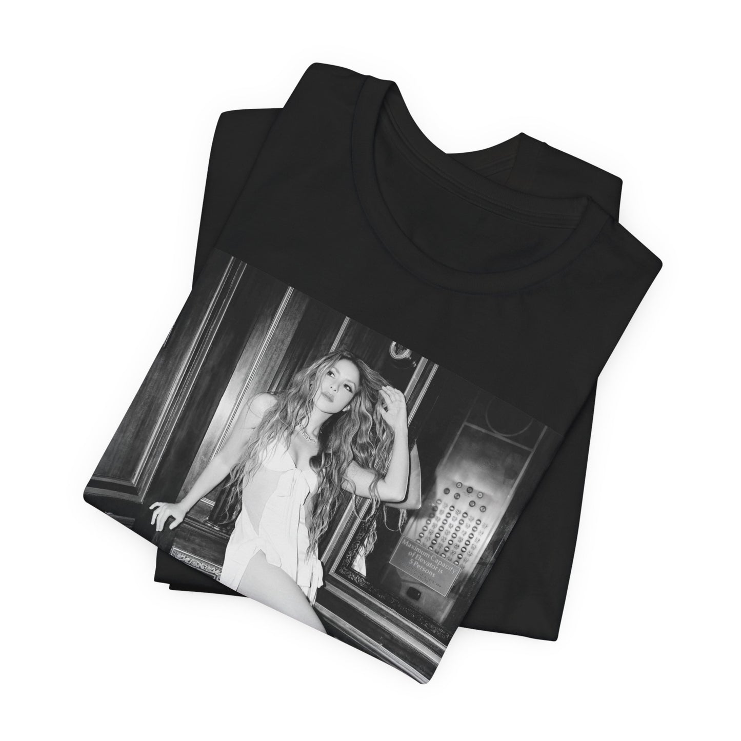 A black graphic t-shirt featuring a retro black and white monochrome graphic or photo of Shakira.
