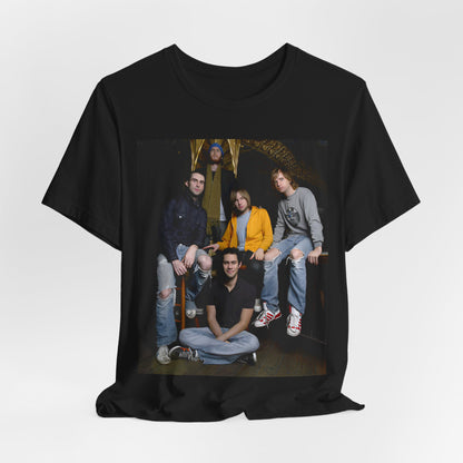 A high-energy, colorful photo of Maroon 5 performing live on stage at a concert, printed on a graphic t-shirt.
