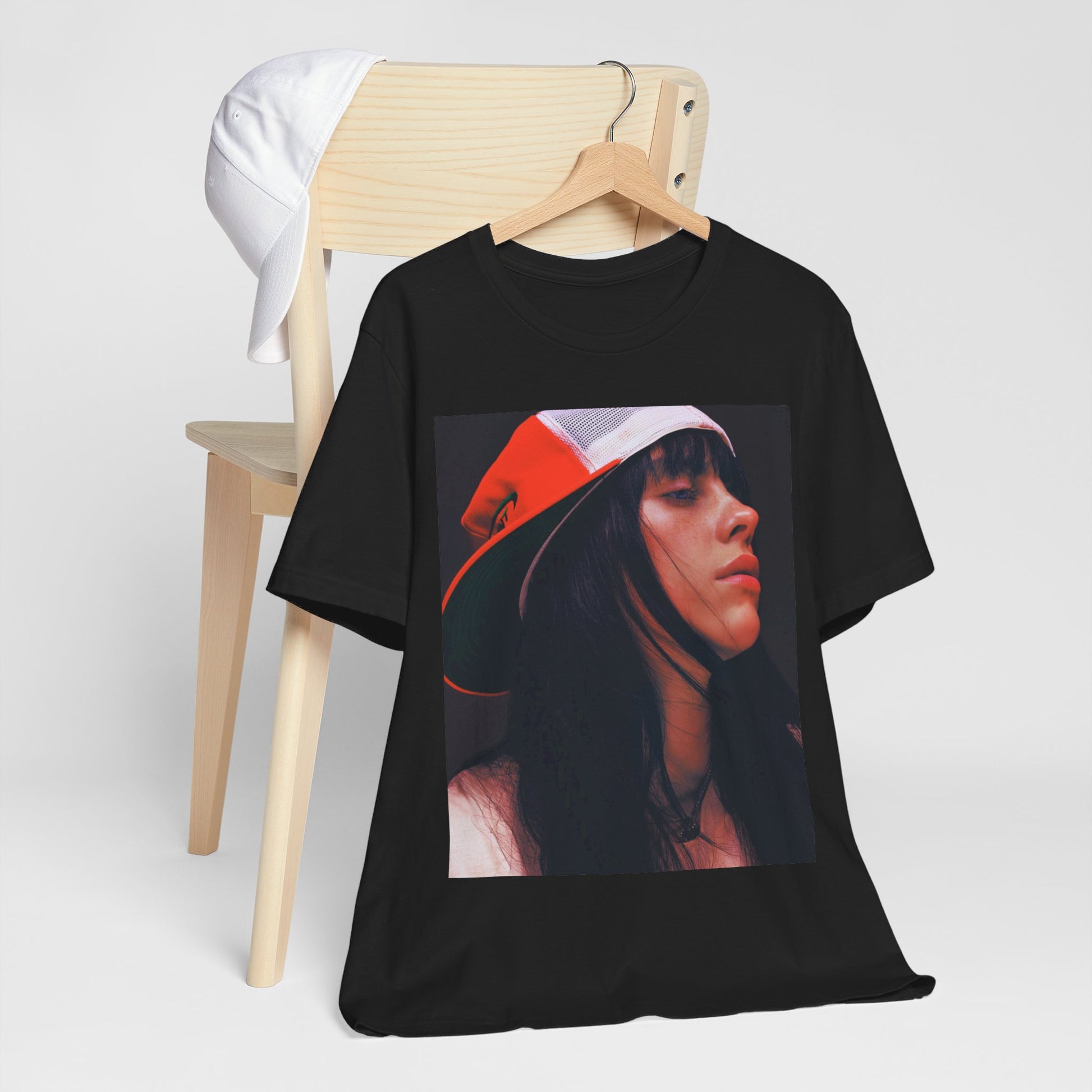 A graphic t-shirt featuring the name 'Billie Eilish' in a raw, urban street-style font.