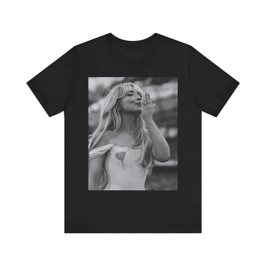 A black graphic t-shirt featuring a graphic or photo of Sabrina Carpenter kissing on stage during a performance.