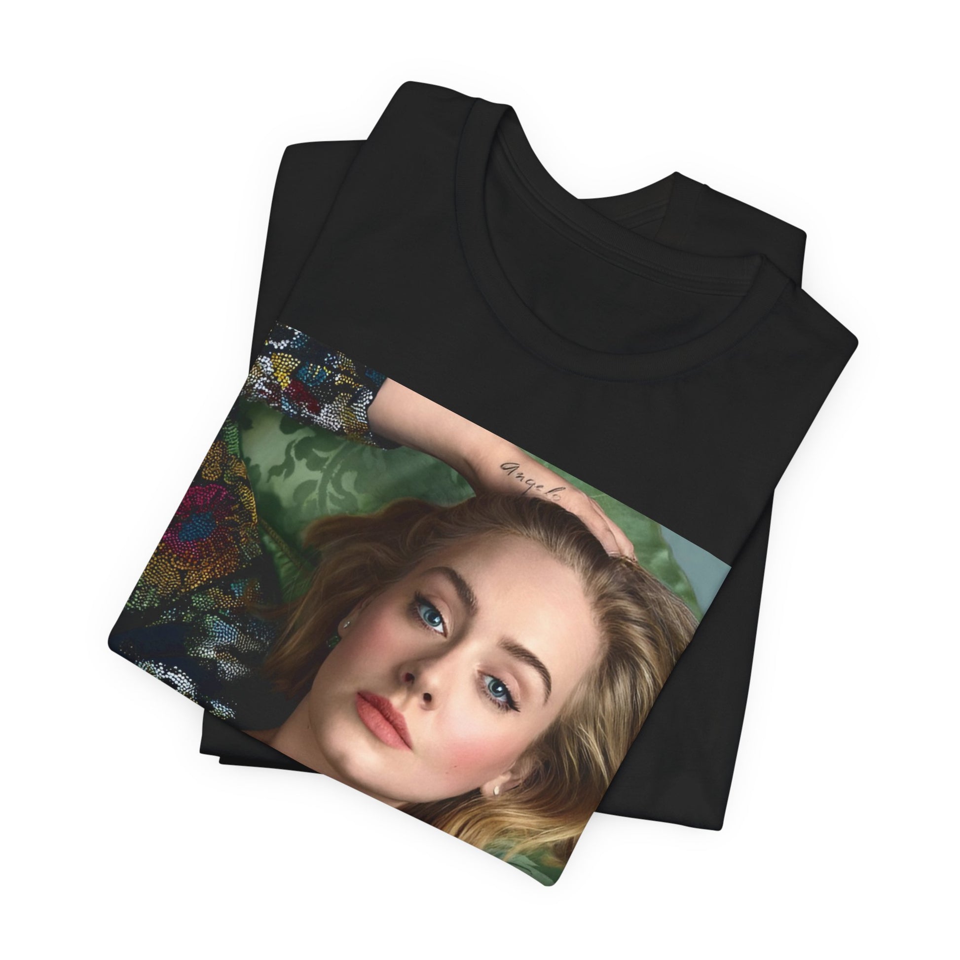 A black graphic t-shirt featuring a photo of Adele, possibly with floral elements or a floral background, showing a serene or contemplative expression.