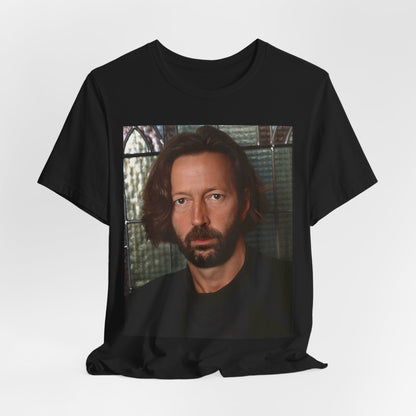 A black graphic t-shirt featuring a portrait graphic of Eric Clapton as a guitar god legend.