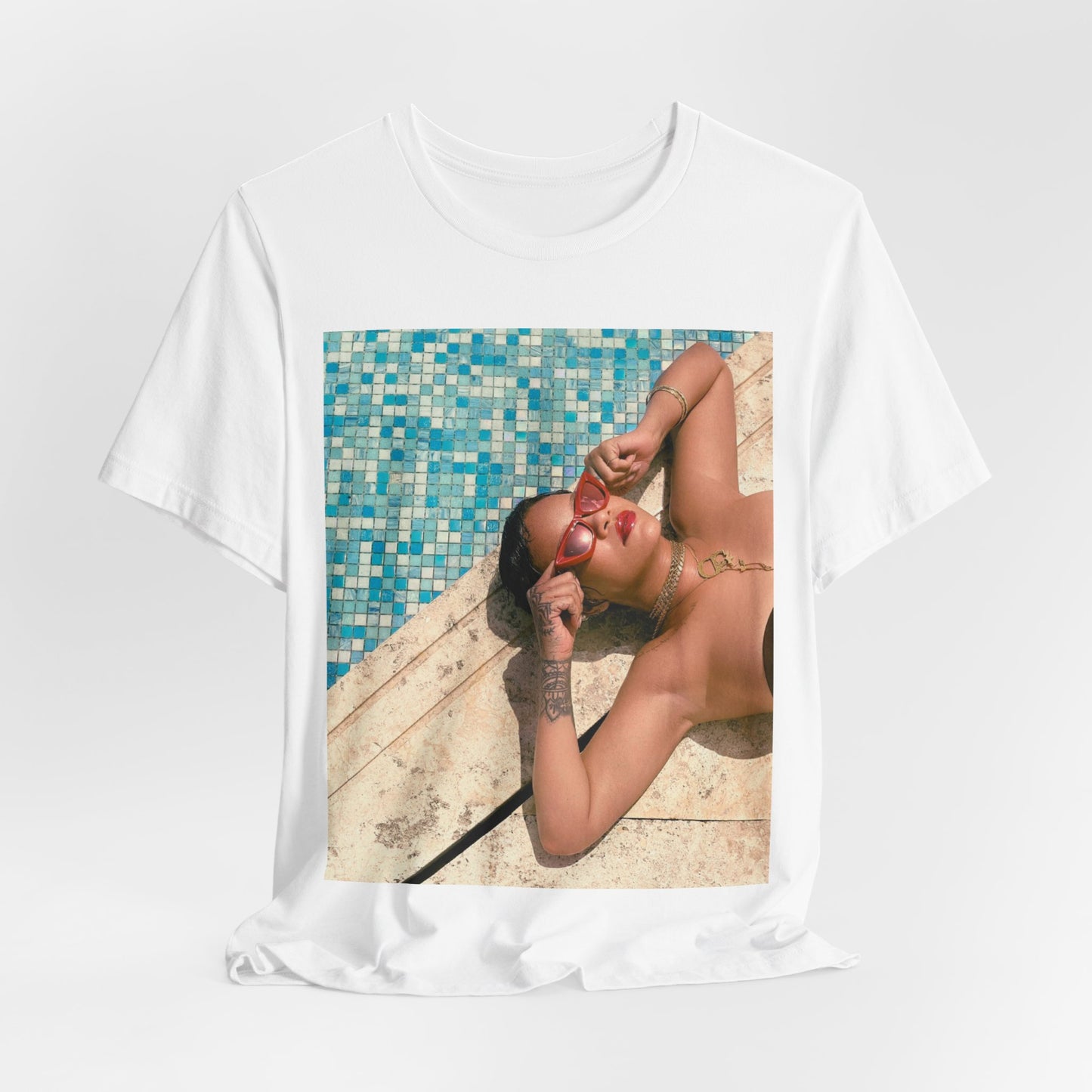 A black graphic t-shirt featuring a graphic of Rihanna in swimwear as a pop star queen.