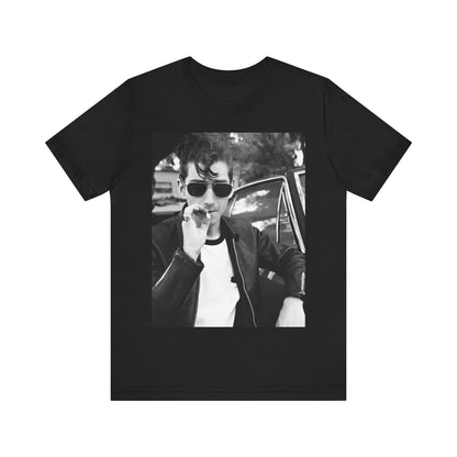 A black graphic t-shirt featuring a classic rock-style graphic of the Arctic Monkeys, possibly with band members in a stylized design.