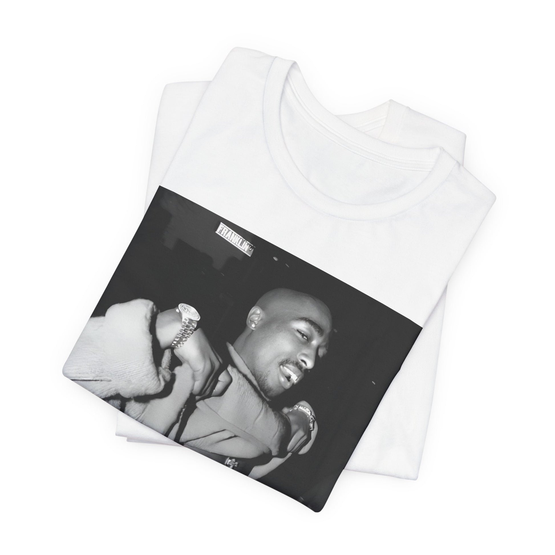 A black graphic t-shirt featuring a vintage hip hop icon graphic of Tupac.