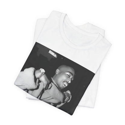 A black graphic t-shirt featuring a vintage hip hop icon graphic of Tupac.