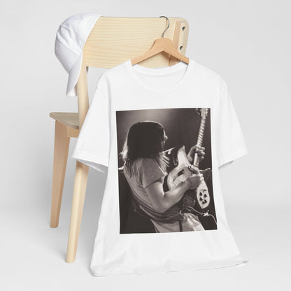 A black graphic t-shirt featuring a black and white graphic or photo of Tame Impala performing live on stage.