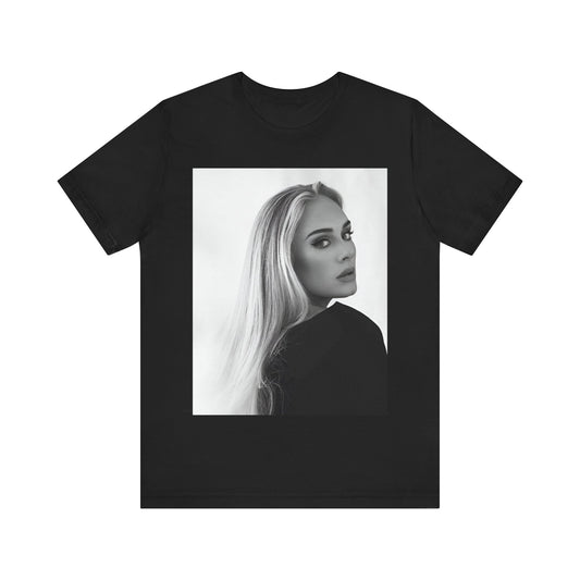 A black graphic t-shirt featuring a black and white, monochromatic portrait of Adele, showing her with a serene or thoughtful expression.