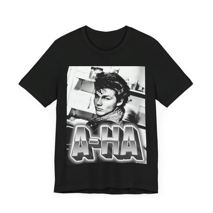 A black graphic t-shirt featuring a retro 1986-style graphic for the band A-HA, possibly with band members in a stylized design.
