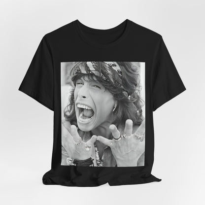 A black graphic t-shirt featuring a candid, dynamic photo of Aerosmith band members on tour in the 1970s, possibly showing action or interaction on stage or backstage.
