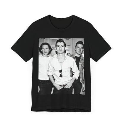 A black graphic t-shirt featuring a vintage-style design related to Arctic Monkeys' 'AM' album era, possibly with the album art or band imagery.