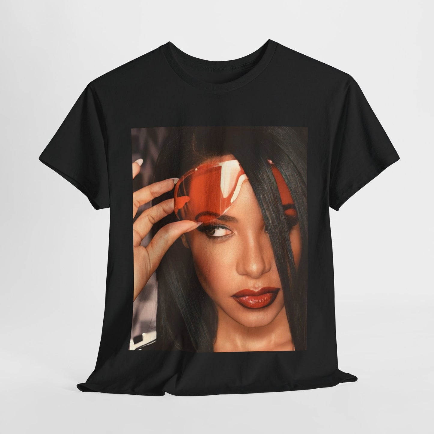 A black graphic t-shirt featuring a 90s hip hop tribute graphic of Aaliyah.