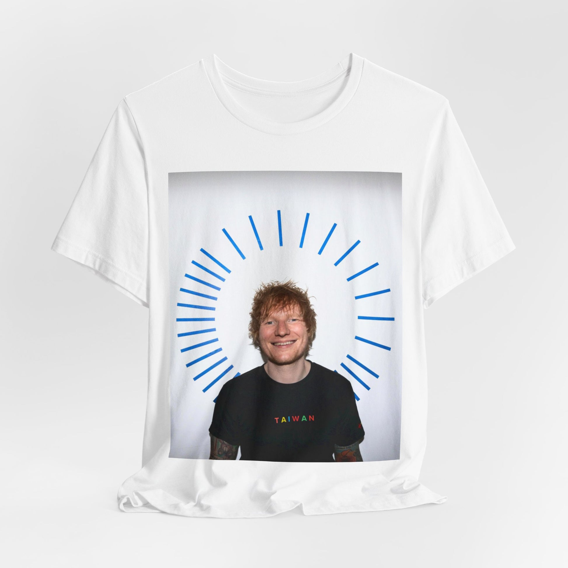 A black graphic t-shirt featuring a classic photo portrait of Ed Sheeran in a folk-pop style.