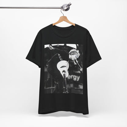 A black graphic t-shirt featuring a vintage graphic of Ed Sheeran performing live.