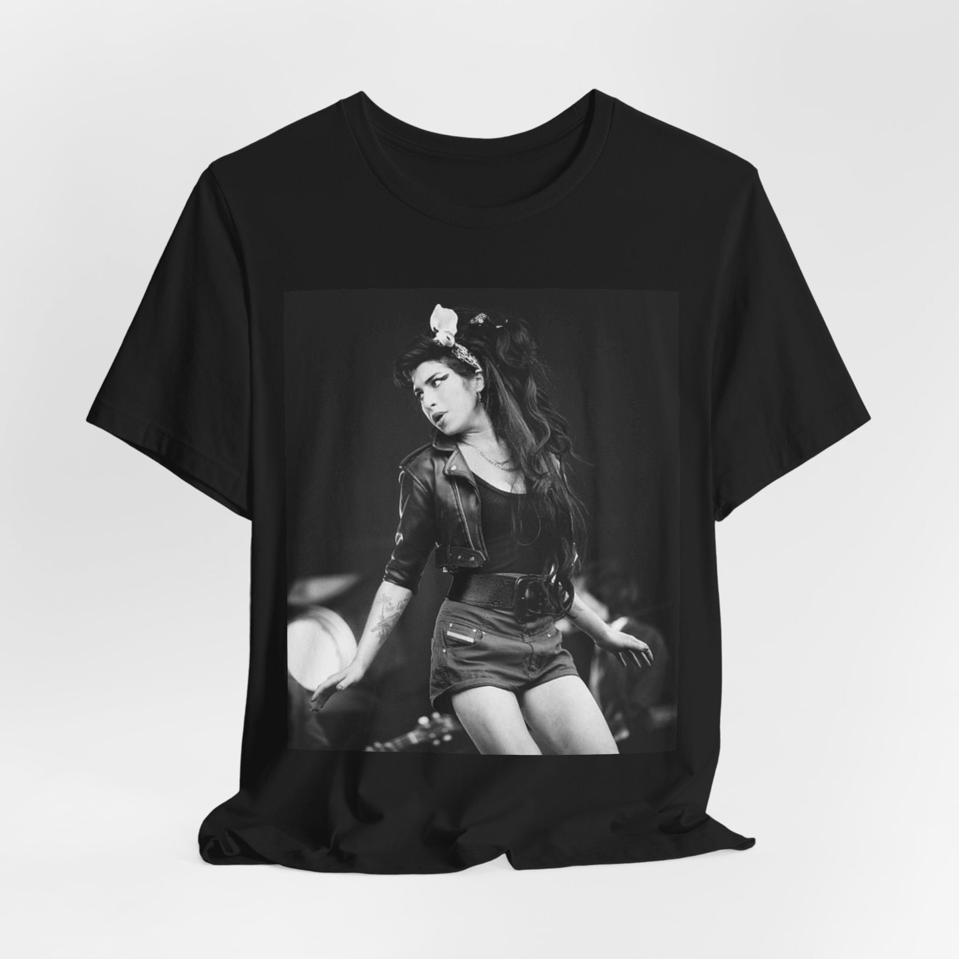 A black graphic t-shirt featuring a graphic related to Amy Winehouse's 'Frank' album era from 2003, possibly with early portrait imagery.