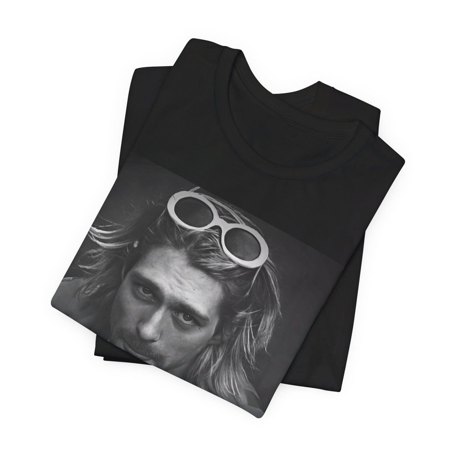 A black graphic t-shirt featuring a photo of Kurt Cobain from Nirvana wearing sunglasses.