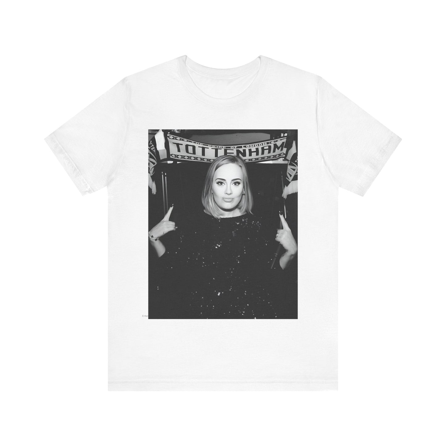 A black graphic t-shirt featuring a photo of Adele in a casual setting, surrounded by fans at a Tottenham event, showing her smiling or interacting.