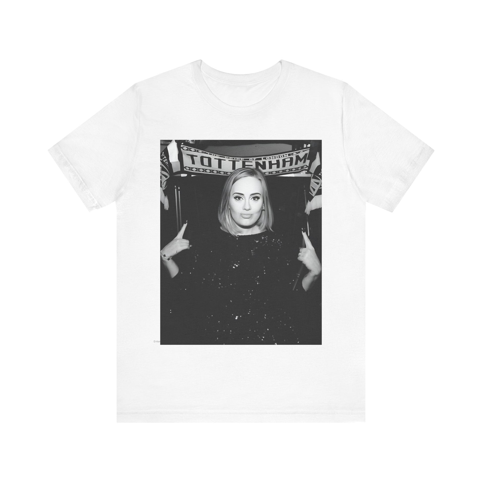 A black graphic t-shirt featuring a photo of Adele in a casual setting, surrounded by fans at a Tottenham event, showing her smiling or interacting.