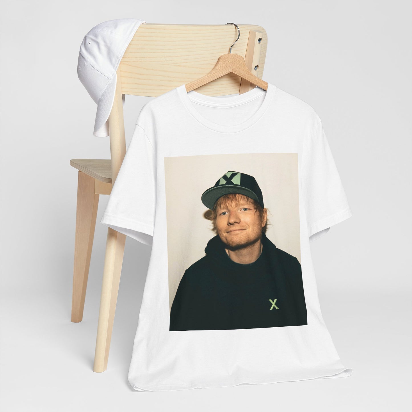 A black graphic t-shirt featuring a glamorous graphic of Ed Sheeran as a global tour icon.
