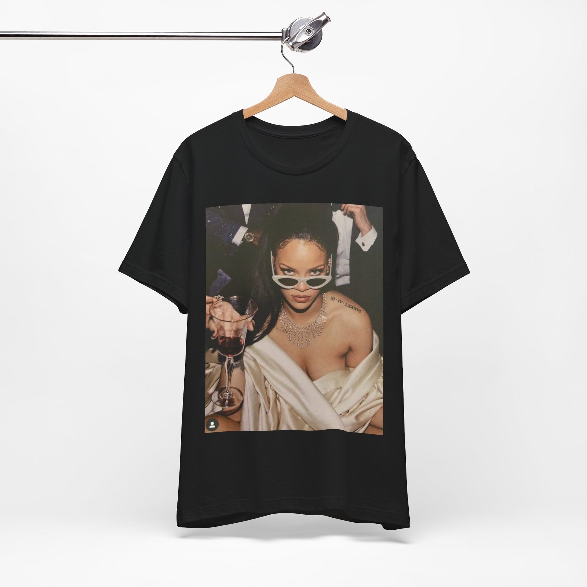 A black graphic t-shirt featuring a graphic of Rihanna as a 'Bad Gal Riri' fashion icon.