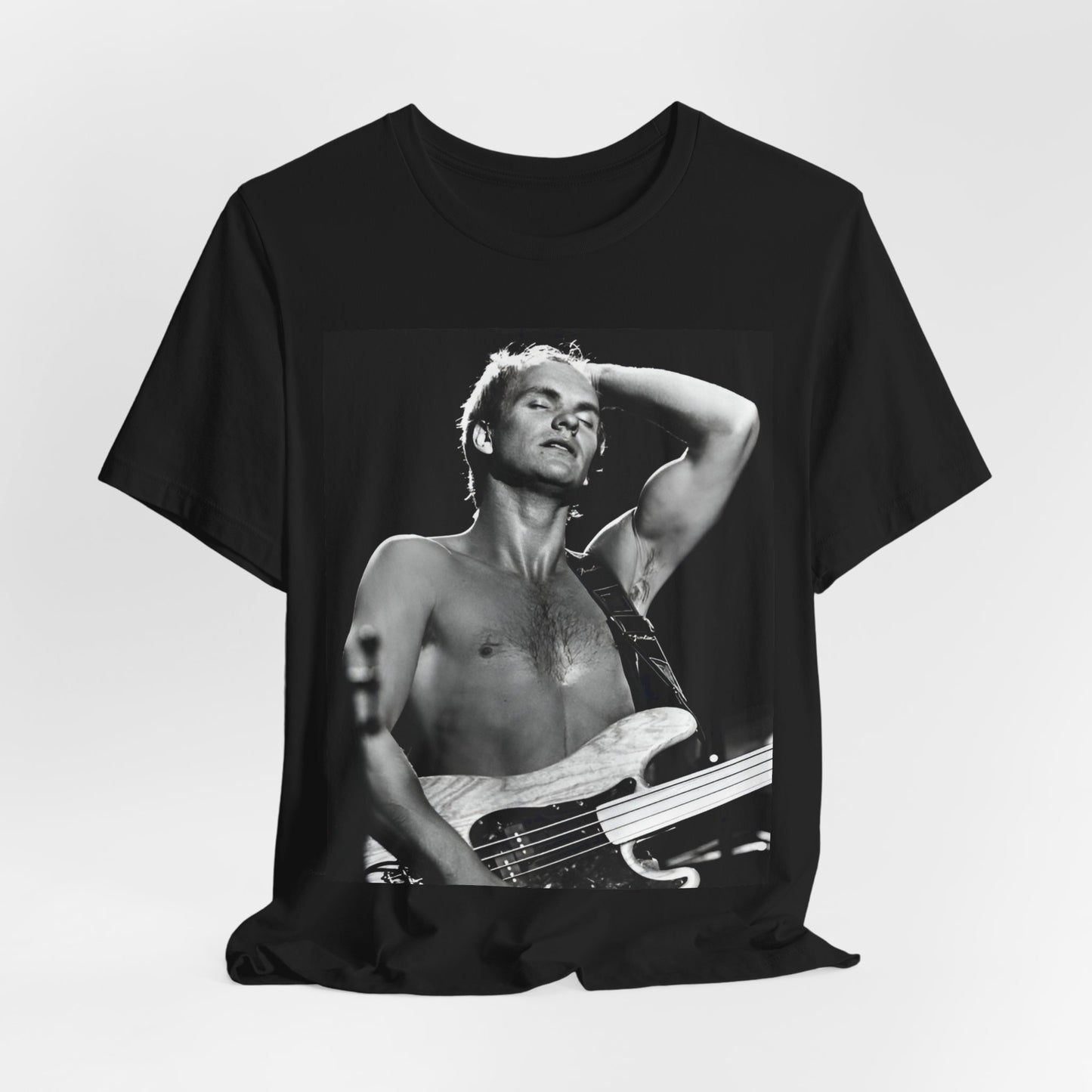 A black graphic t-shirt featuring a graphic or photo of Sting performing live on stage in 1983.