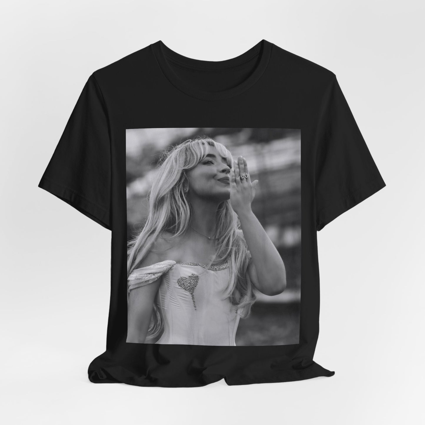 A black graphic t-shirt featuring a graphic or photo of Sabrina Carpenter kissing on stage during a performance.