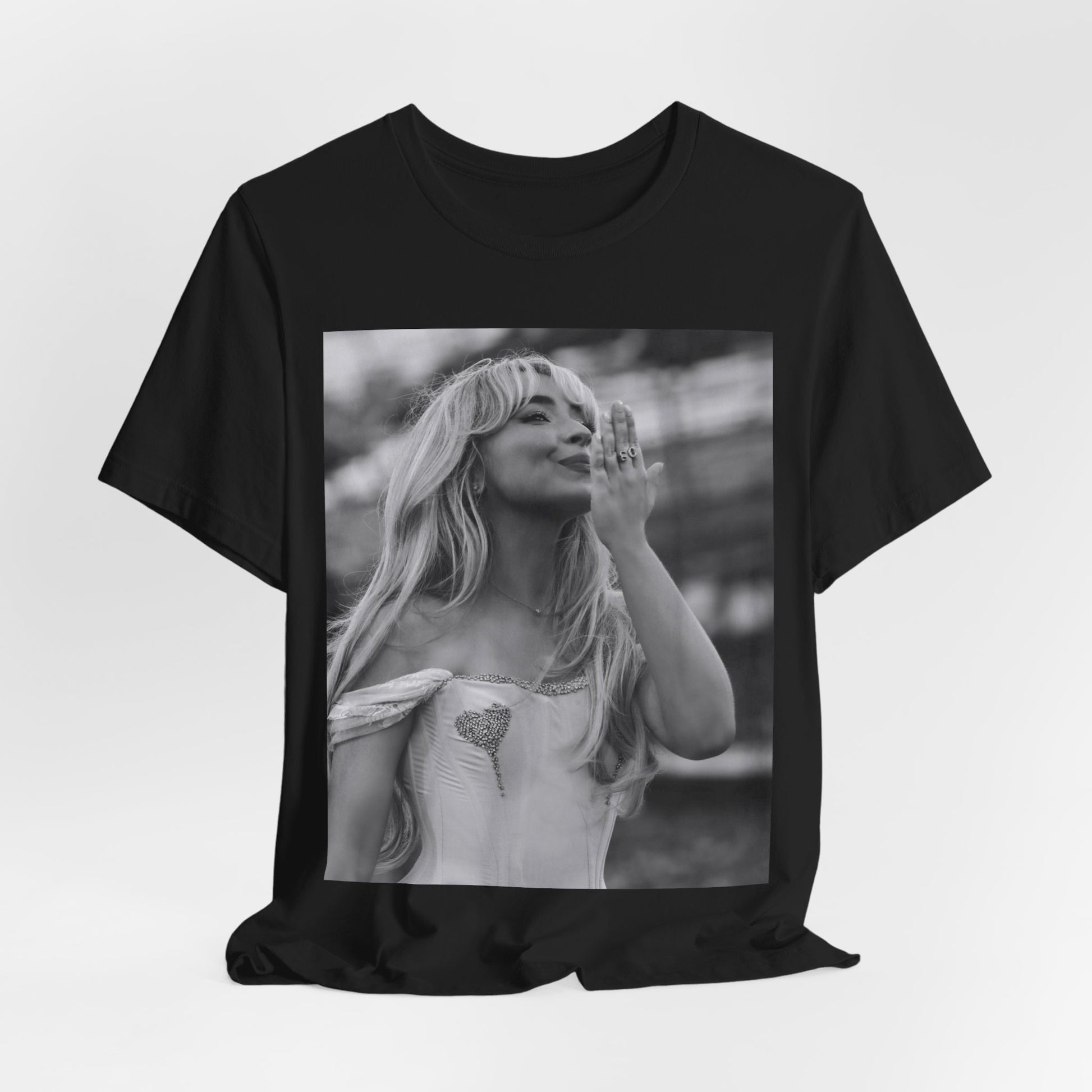 A black graphic t-shirt featuring a graphic or photo of Sabrina Carpenter kissing on stage during a performance.