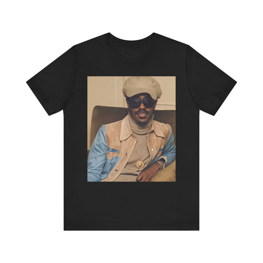 A black graphic t-shirt featuring a retro graphic related to Stevie Wonder's 'Songs in the Key of Life' album era.