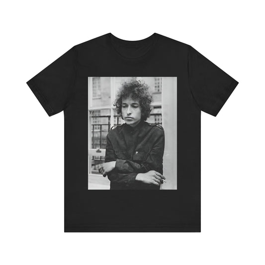A black graphic t-shirt featuring a black and white graphic of Bob Dylan from the folk revival era.