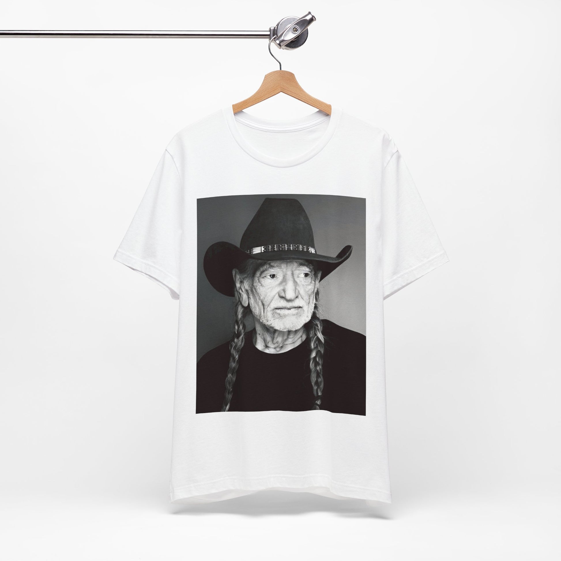 A black graphic t-shirt featuring a graphic of Willie Nelson with his iconic guitar 'Trigger'.