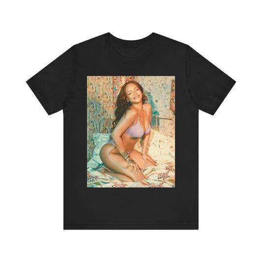 A black graphic t-shirt featuring a graphic of Rihanna with a beauty aesthetic.